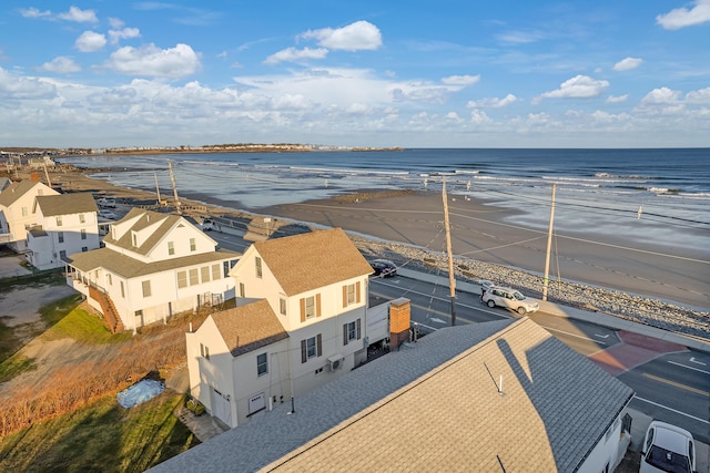 drone / aerial view featuring a beach view and a water view