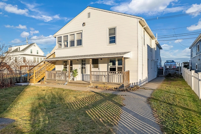 view of front facade with covered porch and a front lawn