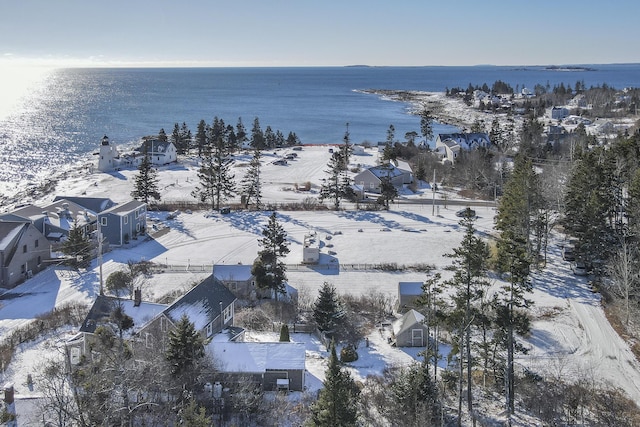 snowy aerial view with a water view