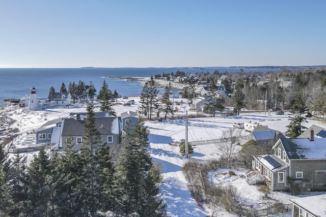 snowy aerial view featuring a water view