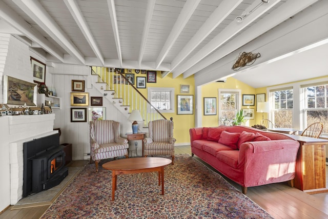 living room with vaulted ceiling with beams and hardwood / wood-style flooring