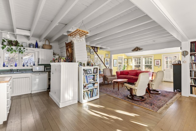 living room with sink, beam ceiling, and hardwood / wood-style floors