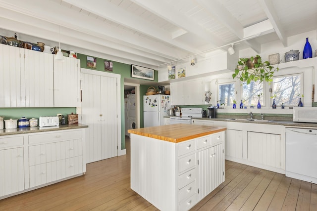 kitchen featuring beamed ceiling, white cabinets, a center island, white appliances, and light hardwood / wood-style flooring