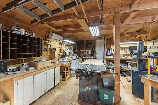 miscellaneous room with a wall unit AC and a workshop area