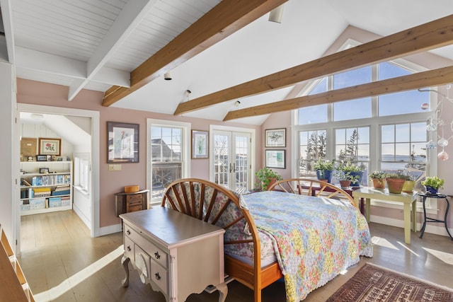 bedroom with french doors, light hardwood / wood-style floors, and lofted ceiling with beams