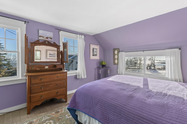 bedroom featuring vaulted ceiling and wood-type flooring