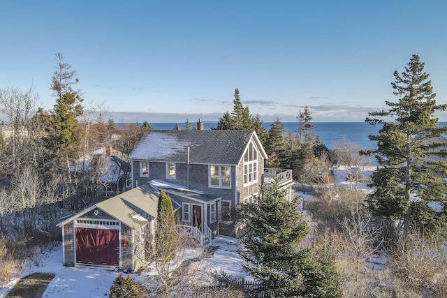 view of front of property featuring a garage and a water view