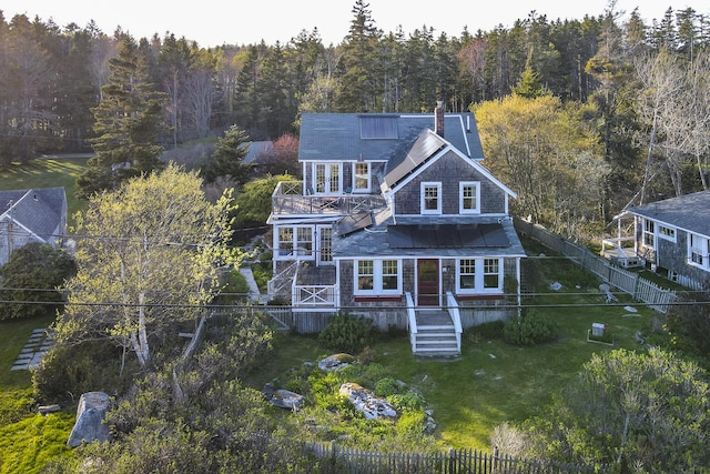 12 Cliff Rd, Bristol, ME 04554 - back of house featuring a wooded view, stairway, a balcony, and a chimney