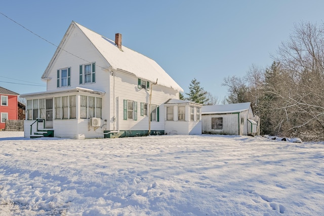 snow covered house with an outbuilding