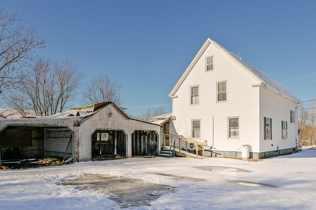 view of snow covered rear of property