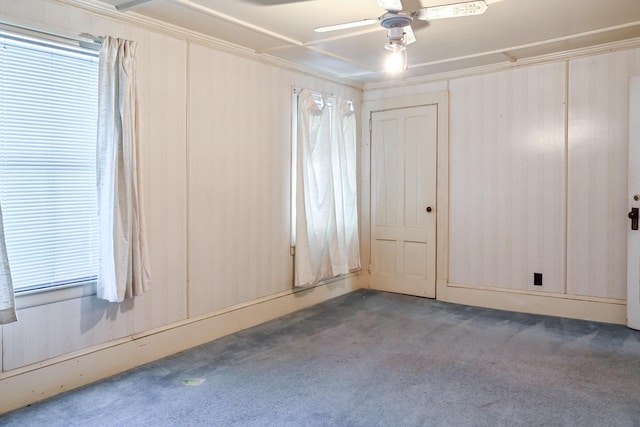 carpeted empty room featuring ceiling fan