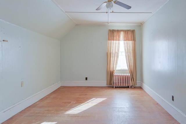 additional living space with light wood-type flooring, radiator, lofted ceiling, and ceiling fan