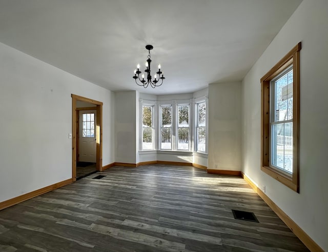 interior space featuring a notable chandelier and dark wood-type flooring