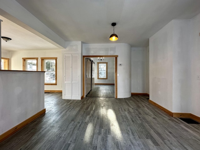 unfurnished dining area featuring plenty of natural light and dark hardwood / wood-style floors