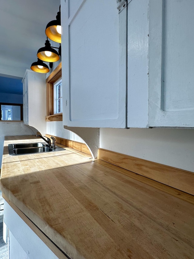 kitchen with white cabinetry and sink