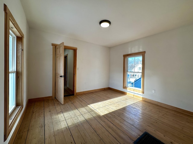 unfurnished room with light hardwood / wood-style floors