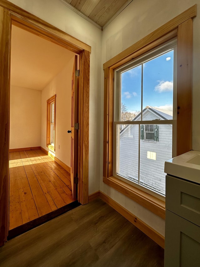 corridor featuring hardwood / wood-style flooring, cooling unit, and wooden ceiling