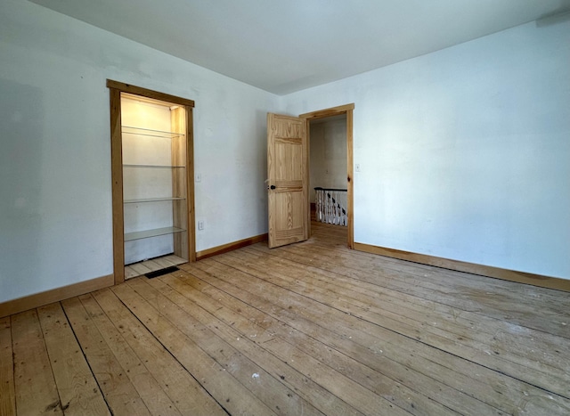 empty room with light hardwood / wood-style floors