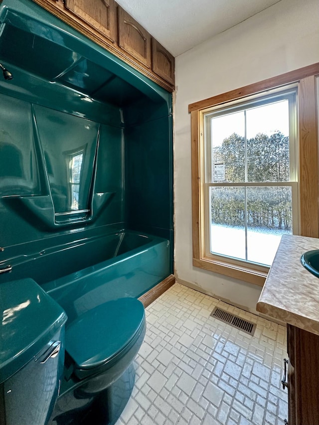 full bathroom featuring vanity, toilet, and bathing tub / shower combination