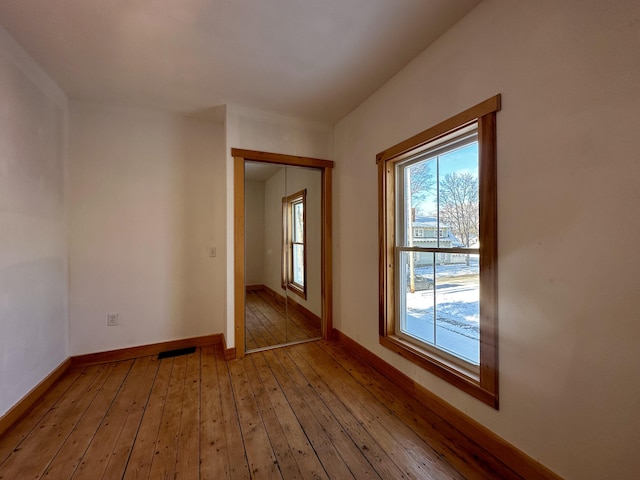 unfurnished room with hardwood / wood-style floors