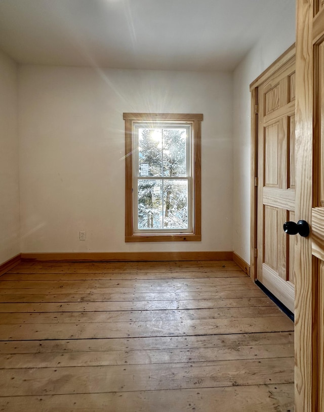 spare room featuring light wood-type flooring