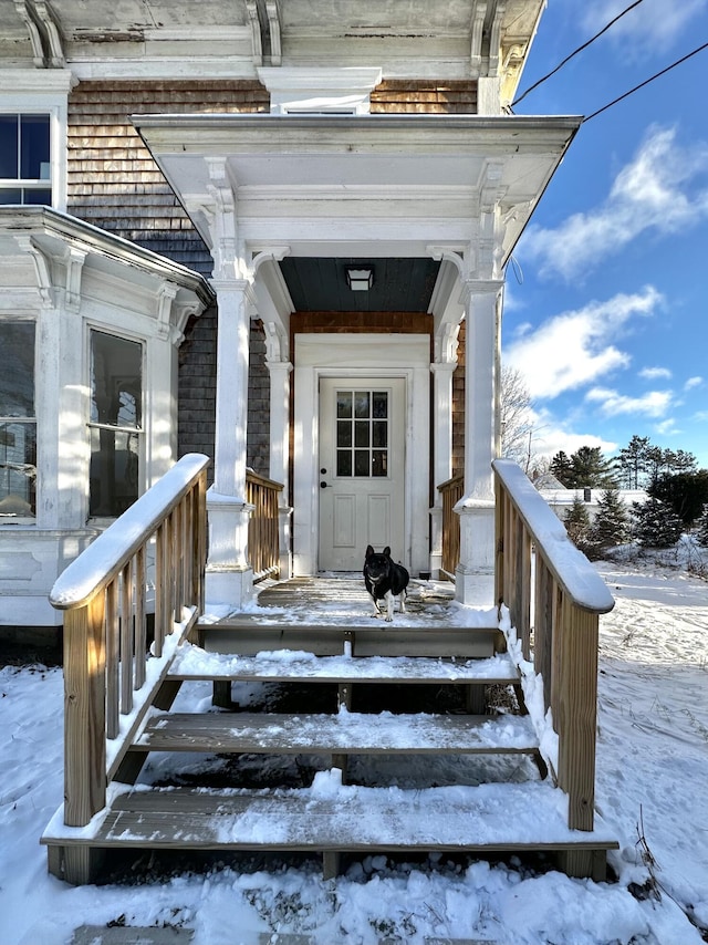 view of snow covered property entrance