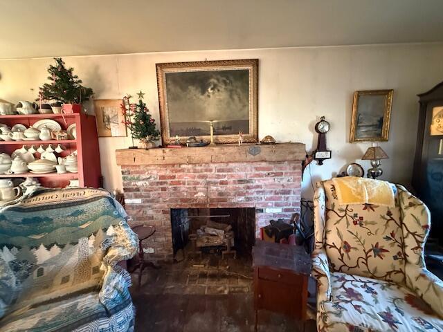 sitting room with a fireplace and hardwood / wood-style floors