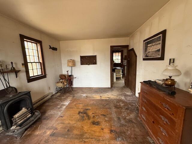21 Talmadge Rd, Talmadge, ME 04492 - living room with a wood stove and a baseboard radiator