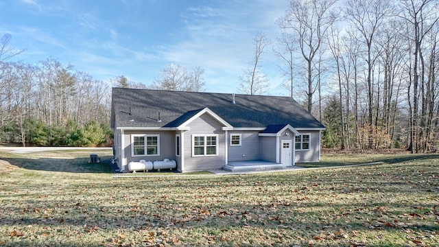 rear view of property with a yard and a patio