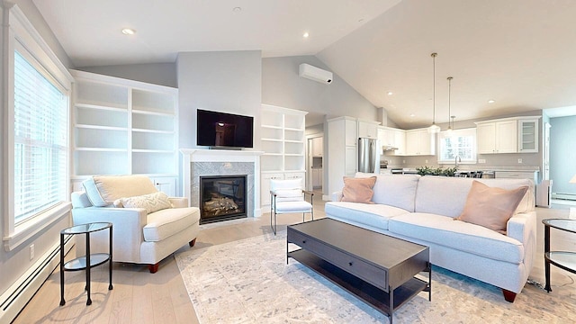 living room featuring a wall mounted air conditioner, high vaulted ceiling, built in shelves, a baseboard radiator, and light hardwood / wood-style floors