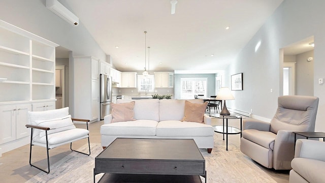 living room with a wall mounted AC and light wood-type flooring