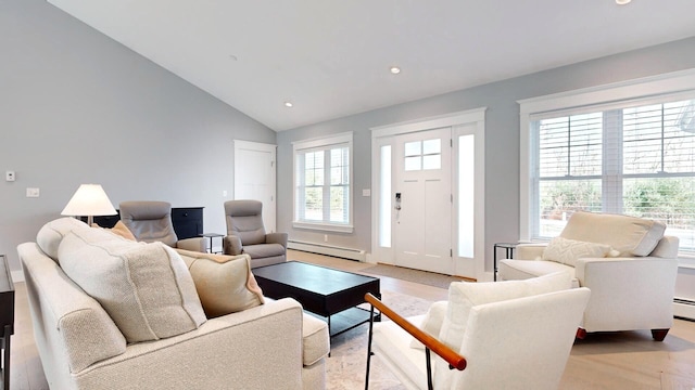 living room with baseboard heating and lofted ceiling