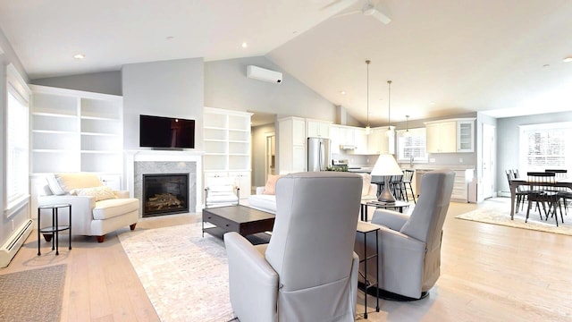 living room featuring a high end fireplace, a wall mounted air conditioner, a baseboard heating unit, high vaulted ceiling, and light hardwood / wood-style floors