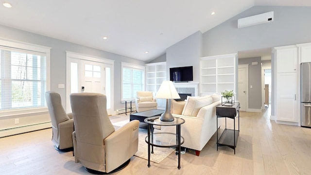 living room featuring a healthy amount of sunlight, light hardwood / wood-style floors, an AC wall unit, and lofted ceiling