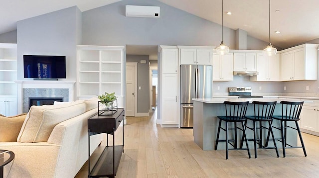 kitchen with pendant lighting, a center island, white cabinetry, and stainless steel appliances