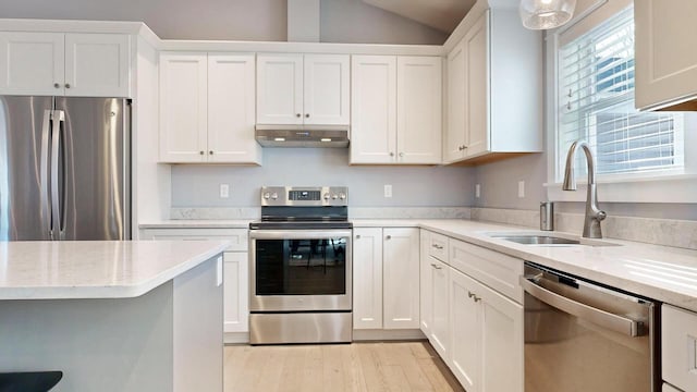 kitchen with appliances with stainless steel finishes, white cabinetry, and sink