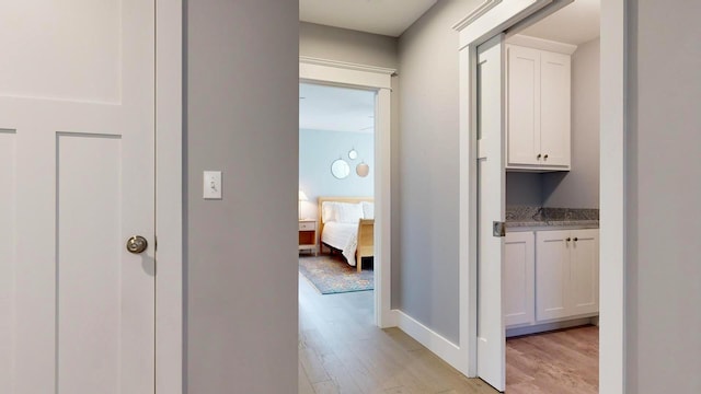 corridor with light hardwood / wood-style floors