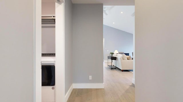 hall featuring light hardwood / wood-style floors and lofted ceiling