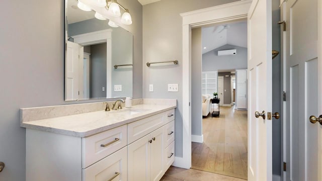 bathroom with vanity and lofted ceiling