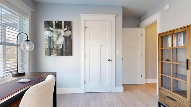 home office with light hardwood / wood-style floors