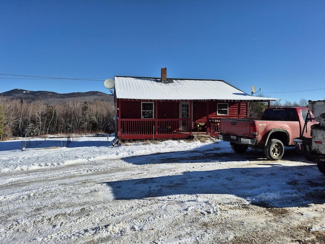 view of front of house featuring a mountain view and a porch