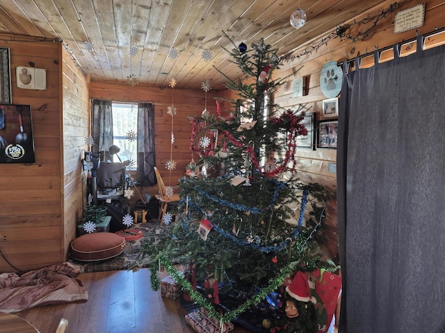 interior space featuring wood walls, hardwood / wood-style floors, and wooden ceiling