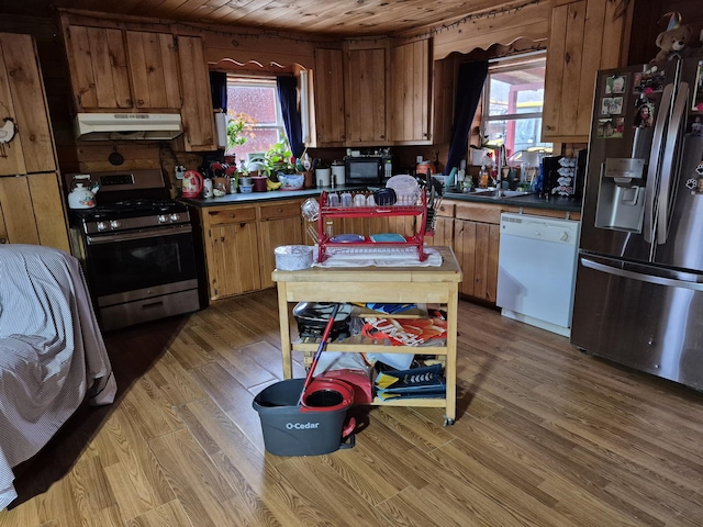 kitchen with sink, wood ceiling, stainless steel appliances, and a wealth of natural light