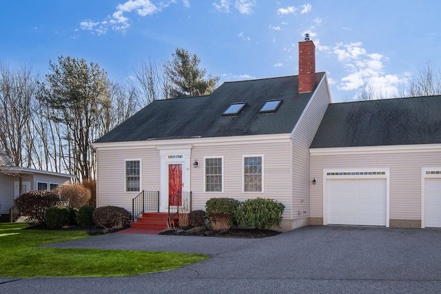 view of front of home with an attached garage, a chimney, aphalt driveway, and roof with shingles