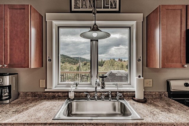 kitchen featuring a wealth of natural light, sink, and light stone countertops