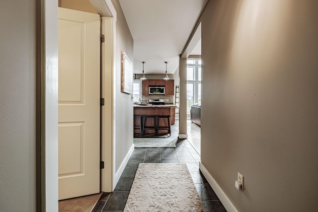 corridor featuring dark tile patterned floors