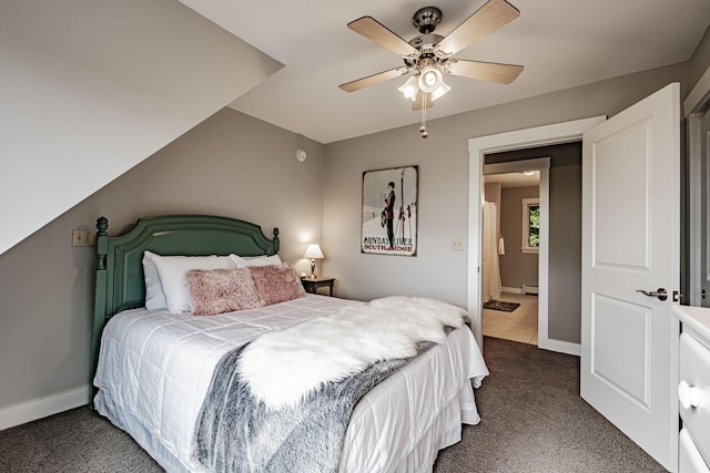 bedroom featuring a baseboard radiator, dark carpet, and ceiling fan