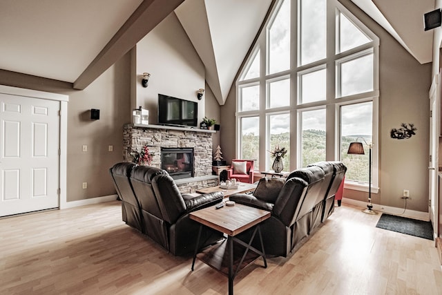 living room featuring a fireplace, high vaulted ceiling, and light hardwood / wood-style flooring