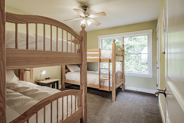 bedroom with ceiling fan and dark carpet