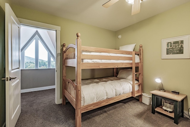 bedroom with dark colored carpet and ceiling fan